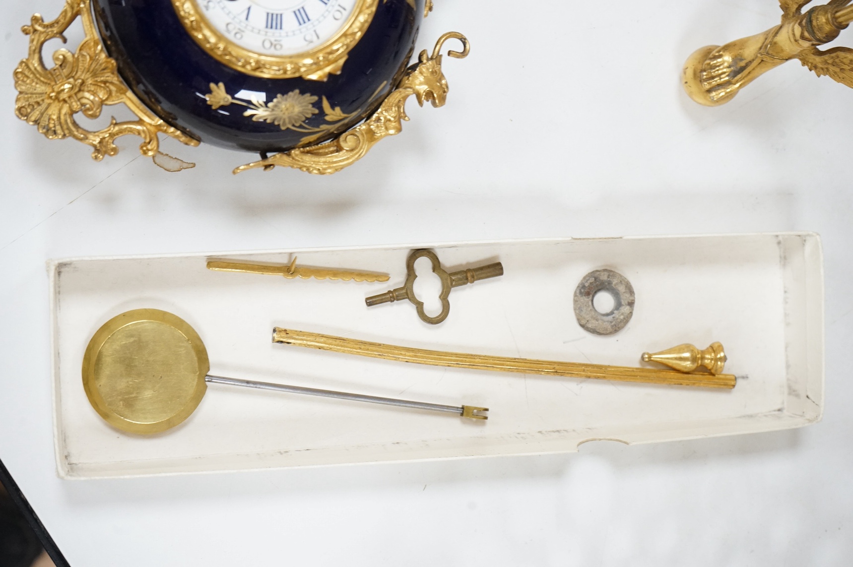 An unusual enamel and gilt brass timepiece, pendant from gilt brass frame, stand 26cm high. Condition - dismantled